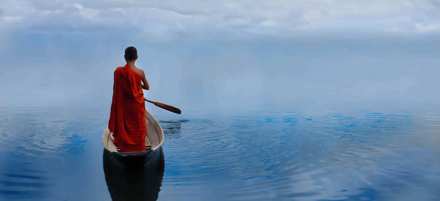 Young monk in boat