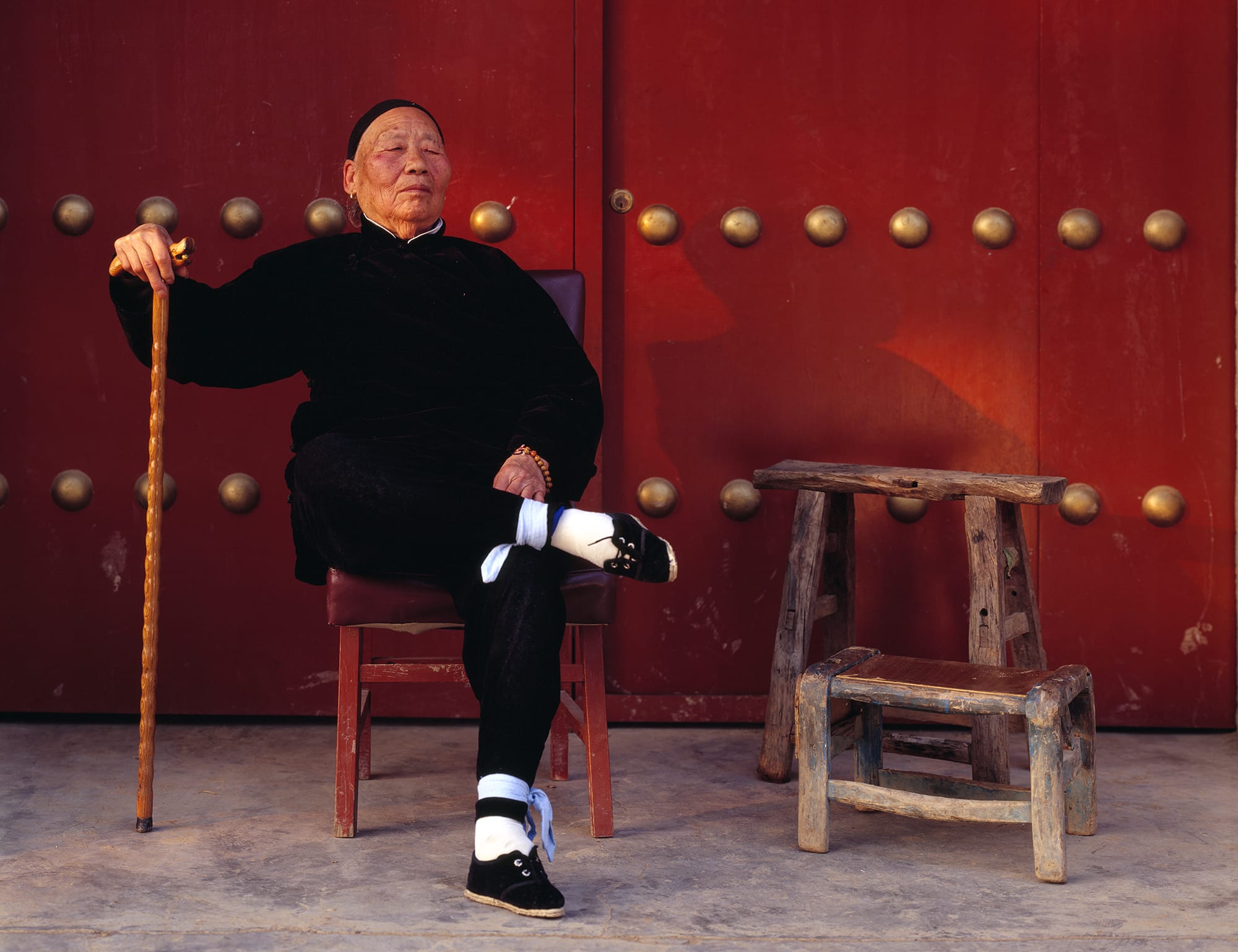 A 93-year-old woman named Li, her posture and facial expression exuding pride in her life and in her precious, three-inch golden lotus feet a sign of true beauty radiates from one's inner light, not just outer adornment.